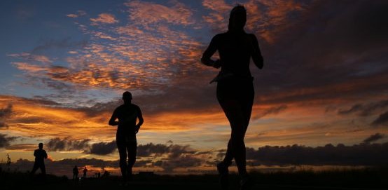 Ironman runners sunset