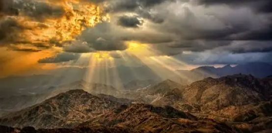 Sunshine and dark clouds over mountains